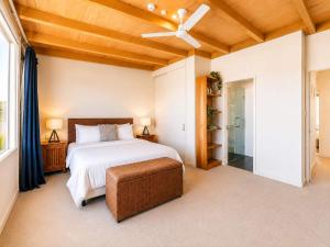a bedroom with a bed and a ceiling fan at The Sands - Villa 28 - Stay Waiheke in Onetangi +21 photos