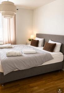 a bedroom with a large bed with two pillows on it at Nordic Central Apartment in Solna