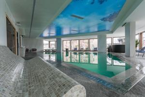 a bedroom with a bed and a swimming pool at Zlatibor Lux Spa Apartments in Zlatibor