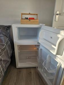 an empty refrigerator with its door open in a room at Modern Fully Contained En-Suite Room With Kitchen in Sidcup +9 photos