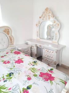 a bedroom with a bed and a dresser and a mirror at City Homes in Makurdu