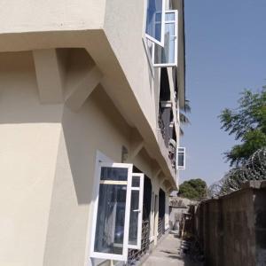 a white building with a window and a balcony at City Homes in Makurdu