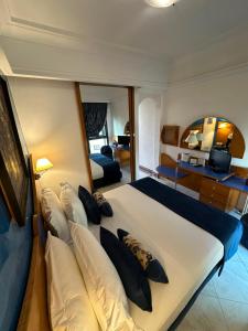 a bedroom with a large white bed with pillows at Hotel Mounia in Fez +71 photos