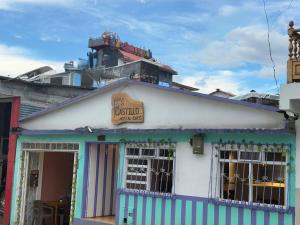 a blue and white building with a sign on it at Hostal Castillo in Filandia
