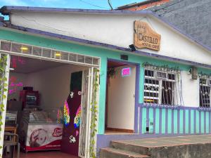 a store with a door open with a skateboard outside at Hostal Castillo in Filandia +8 photos