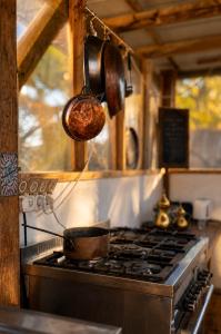 a kitchen with a stove with a pot on it at Tobiana Desert Lodging Negev in ‘Ezuz