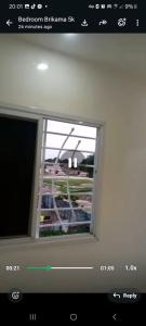 a window in a room with a view of a building at Apartment Busumbala in Busumbala