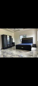 a large room with two beds and two windows at Apartment Busumbala in Busumbala