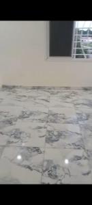 a tile floor in a room with a window at Apartment Busumbala in Busumbala
