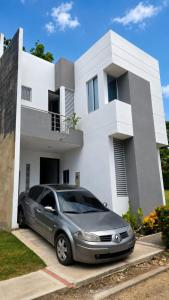 a silver car parked in front of a house at Bambú Alojamiento in Carmen de Apicalá