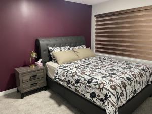 a bedroom with a bed and a night stand at Lakeview 2Bedroom Walkout Suite with Trail View in Winnipeg