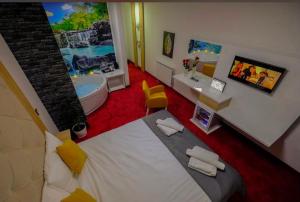 a bedroom with a large bed and a bath tub at Delux Apartmani Bulevar in Sarajevo