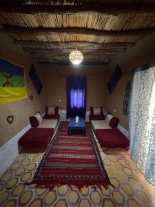 a room with couches and a table on a rug at Guest House For Rent Merzane in Merzane