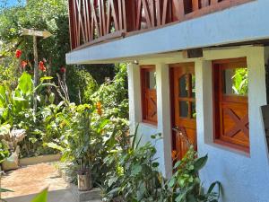 a house with a wooden door and a balcony at Casa Hostal Samaria in Altagracia +10 photos
