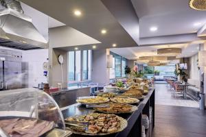 a buffet line with many different types of food at Hotel bh El Poblado in Medellín +25 photos