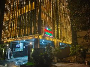 a building covered in christmas lights at night at HoTEL MADHAVI PRIME in Guntūr