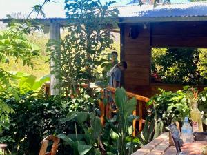 a man standing on a porch of a house at Casa Hostal Samaria in Altagracia