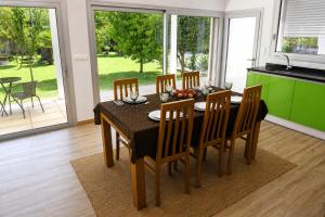 a dining room with a table and eight chairs at Casa da Tapada - Grupo Casas Vale do Lima in Ponte de Lima