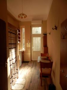 a room with a hallway with a table and a window at Cute apartment close to the center in Budapest
