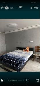 a bedroom with a bed with a teddy bear on it at Vladimir City 60 in Volodymyr-Volynskyi