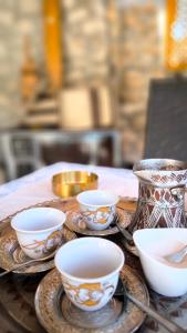a table with plates and cups on a table at B&B Hidden gem Blagaj in Blagaj