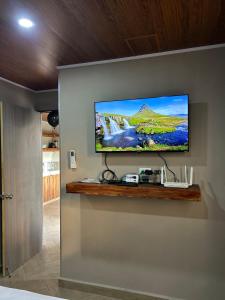 a flat screen tv hanging on a wall at Boaco Suites - Apartments in Boaco +5 photos