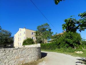 una pared de piedra junto a una carretera con un edificio en Apartment Deluxe, en Rovinj