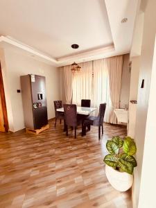a living room with a table and chairs and a couch at Excutive suites in Kyebando