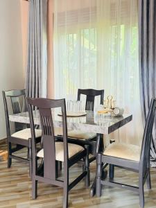 a dining room with a table and chairs at Excutive suites in Kyebando +17 photos