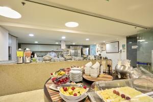 a buffet line with plates of food in a restaurant at Hotel bh Bicentenario in Bogotá +13 photos