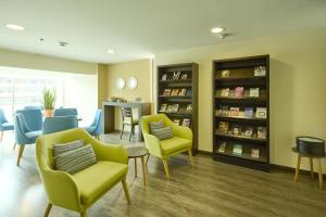 a waiting room at a hospital with chairs and books at Hotel bh Usaquén in Bogotá
