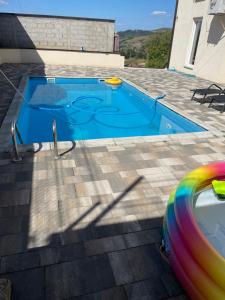 a swimming pool with a frisbee next to a house at Villa Pazar na dlanu in Novi Pazar +5 photos