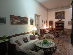 a living room with couches and a table in it at Casa rosa 2 in Mercedes