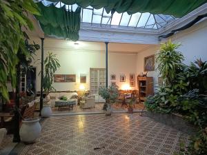 a living room filled with lots of plants at Casa rosa 2 in Mercedes