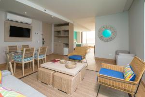 a living room with a couch and chairs and a table at bh Barranquilla in Barranquilla
