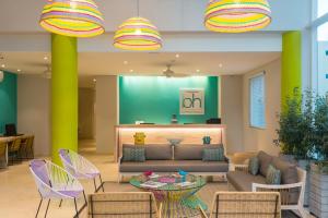 a lobby with a couch and chairs and a table at bh Barranquilla in Barranquilla +10 photos