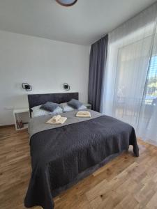 a bedroom with a large bed with two hats on it at Apartmány Koliba in Turčianske Teplice +57 photos