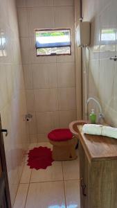 a bathroom with a shower with a toilet and a sink at Recanto Salto Ano Bom in Corupá