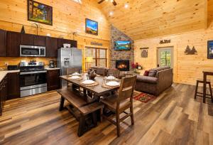 a kitchen and living room with a table in a cabin at Black Bear Lodge in Pigeon Forge