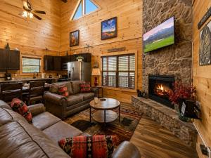 a living room with a couch and a fireplace at Black Bear Lodge in Pigeon Forge