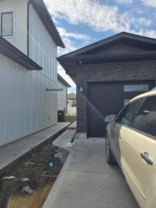 a car parked in front of a garage at The Vilaskan in Saskatoon