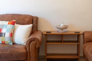 a living room with a couch and a side table at Villa Katerina BBQ & pool! in Metaxáta