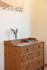a wooden dresser with a vase on top of it at Villa Katerina BBQ & pool! in Metaxáta