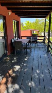 a patio with a table and chairs on a deck at Mobile Home ABC in Donji Karin