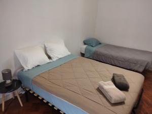 a bedroom with two beds and a table and a chair at The Tram 18 Space in Lisbon