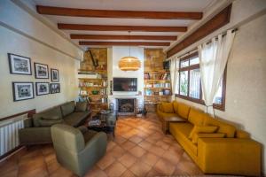 a living room with two couches and a fireplace at Studio Appartement Perdicaris en rez de jardin - maison dhotes Dar Tanja in Tangier