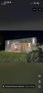 a picture of a house at night at La Casona Posada in Florencio Sánchez