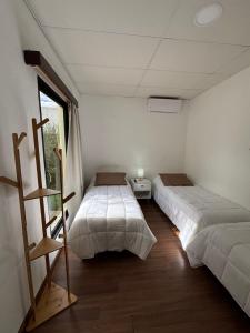 a bedroom with two beds and a window at La Casona Posada in Florencio Sánchez +3 photos