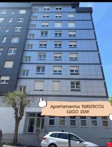 a building with an apple sign in front of it at LUGO Stay in Lugo