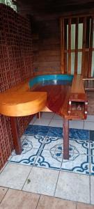 a wooden table sitting on top of a tiled floor at Cabaña Don Jorge in Puerto Rico